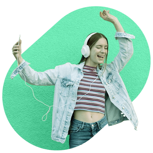 person in a denim jacket dances while listening to music.